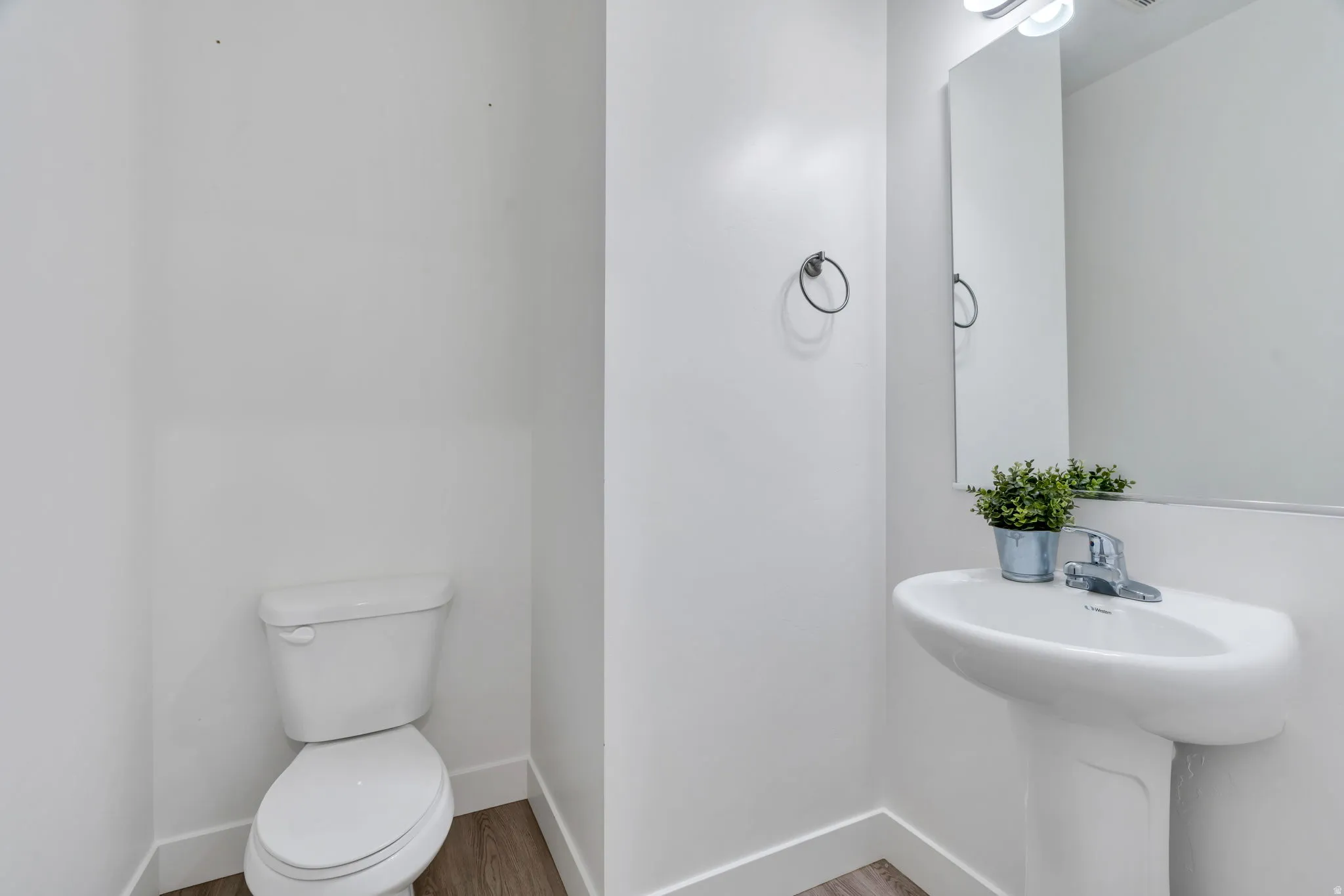 Bathroom featuring toilet and wood finished floors