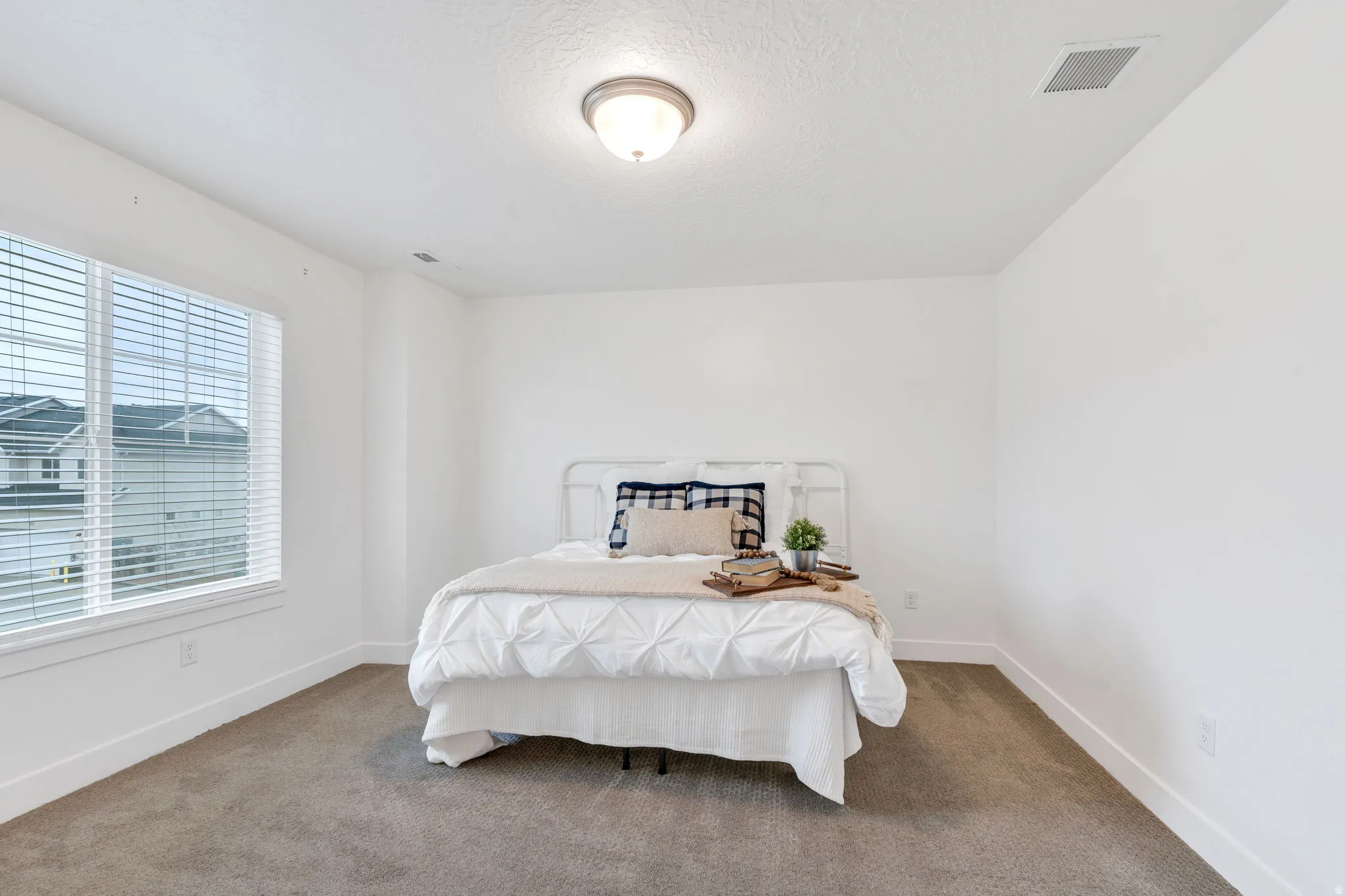 Bedroom featuring carpet floors and a textured ceiling