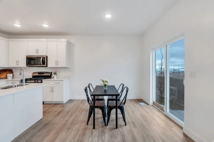 Dining space with light wood finished floors and recessed lighting