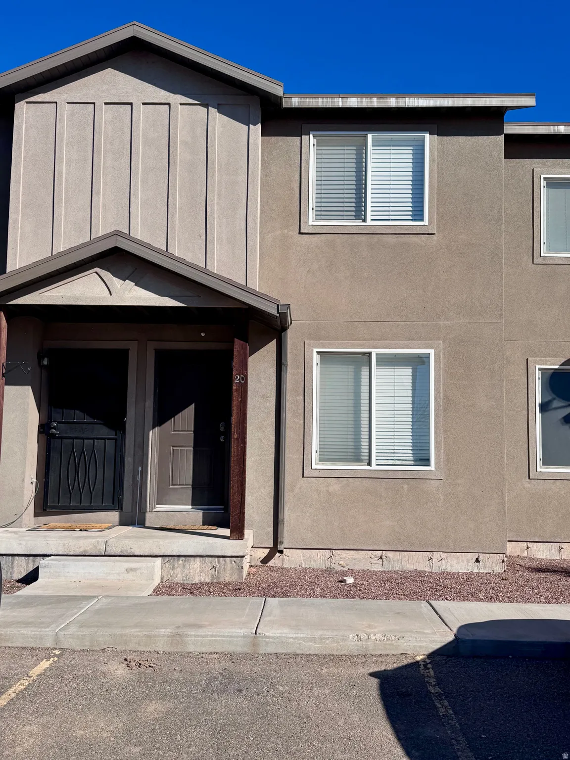 View of front of home with covered porch and stucco siding