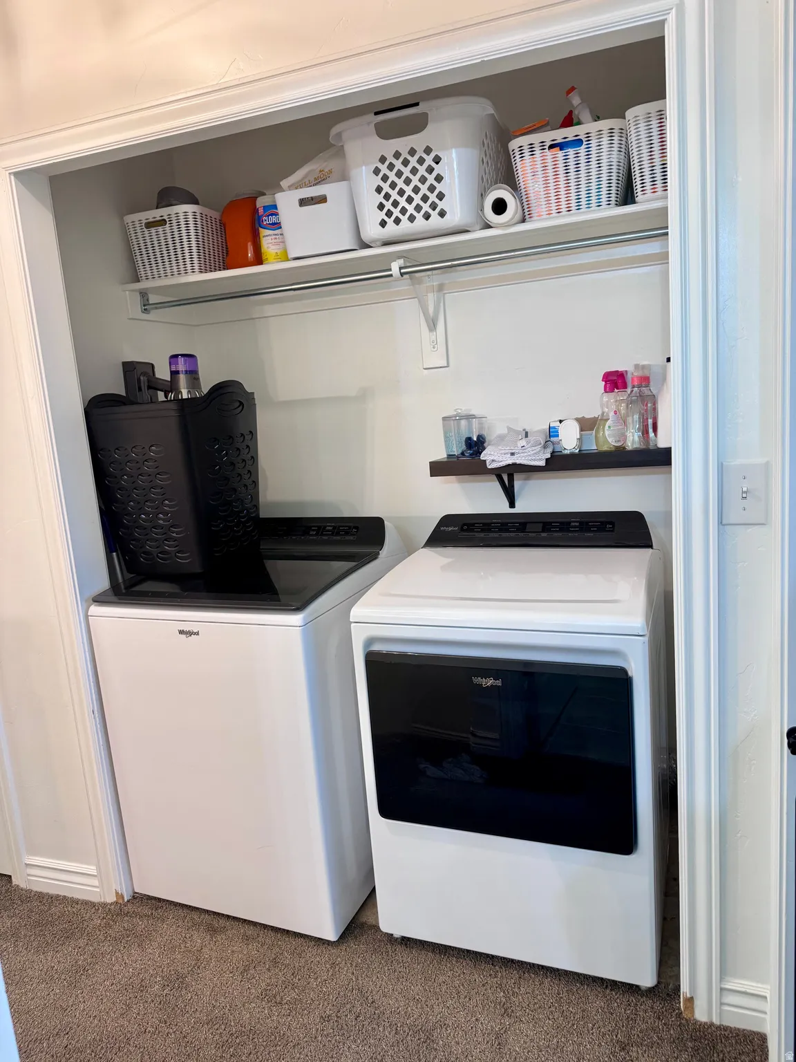 Laundry room with dark carpet and washing machine and dryer
