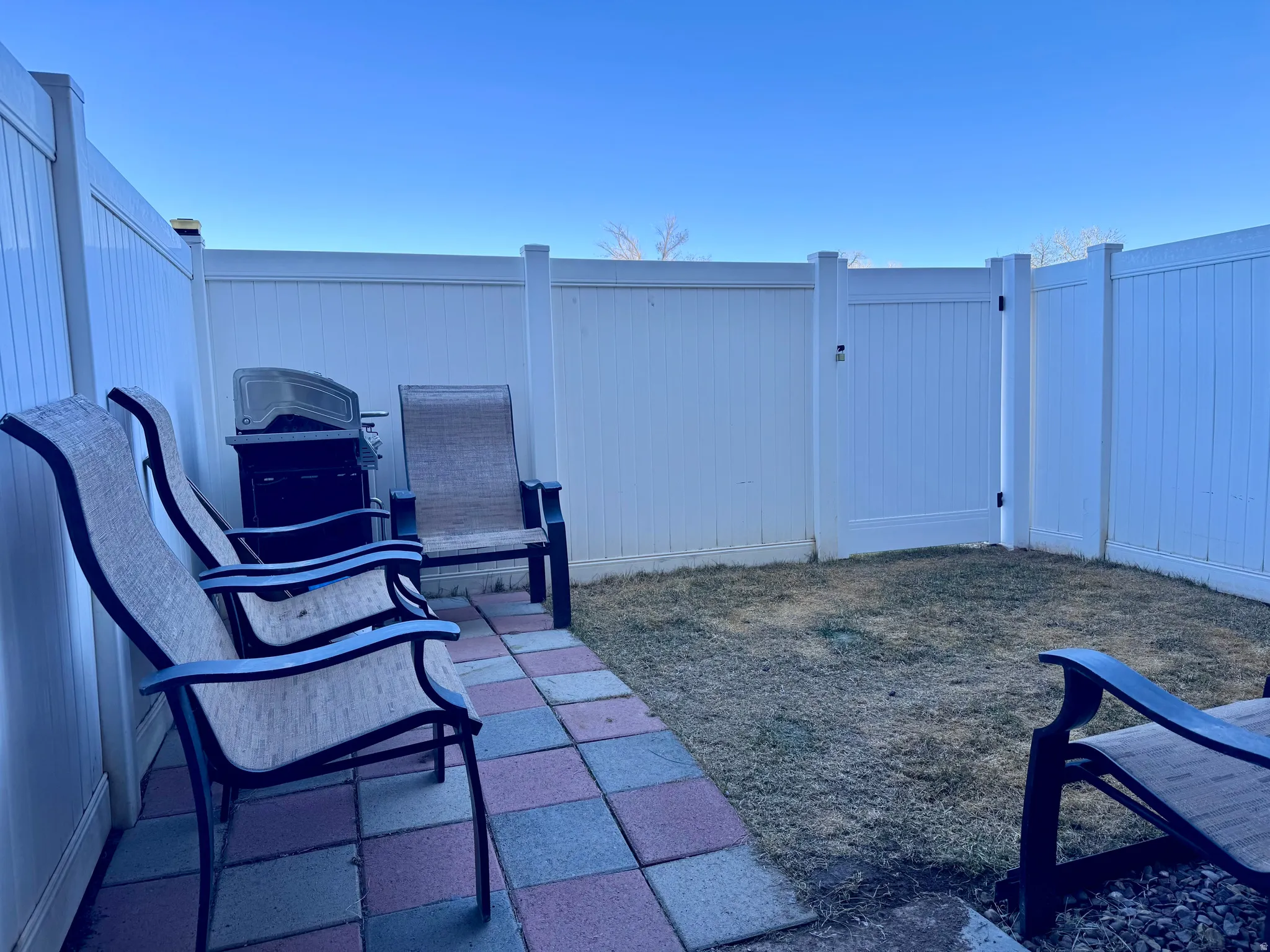 View of patio with a grill