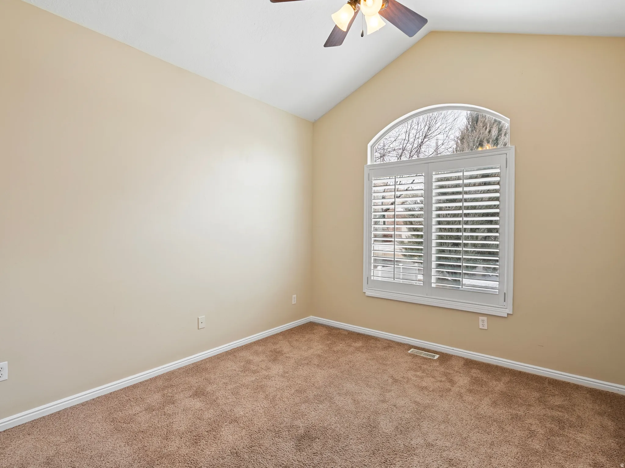 Unfurnished room with ceiling fan and carpet floors