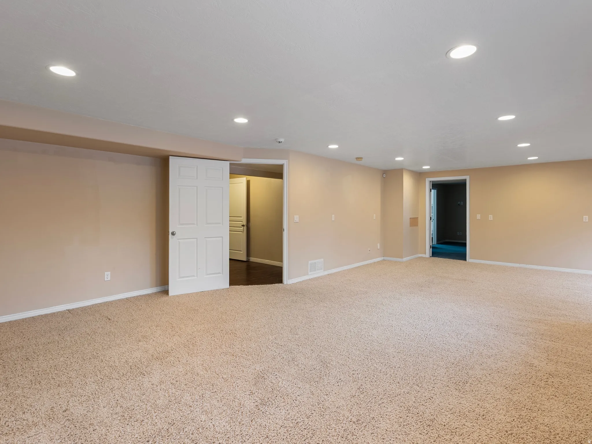 Below grade area featuring carpet floors and recessed lighting