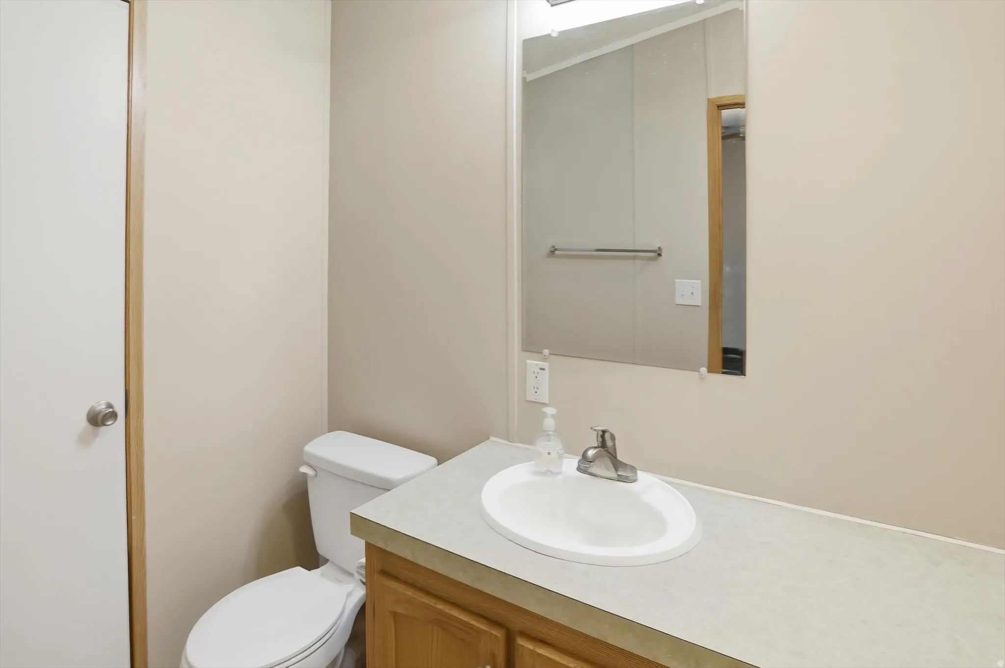 Half bathroom featuring vanity and toilet