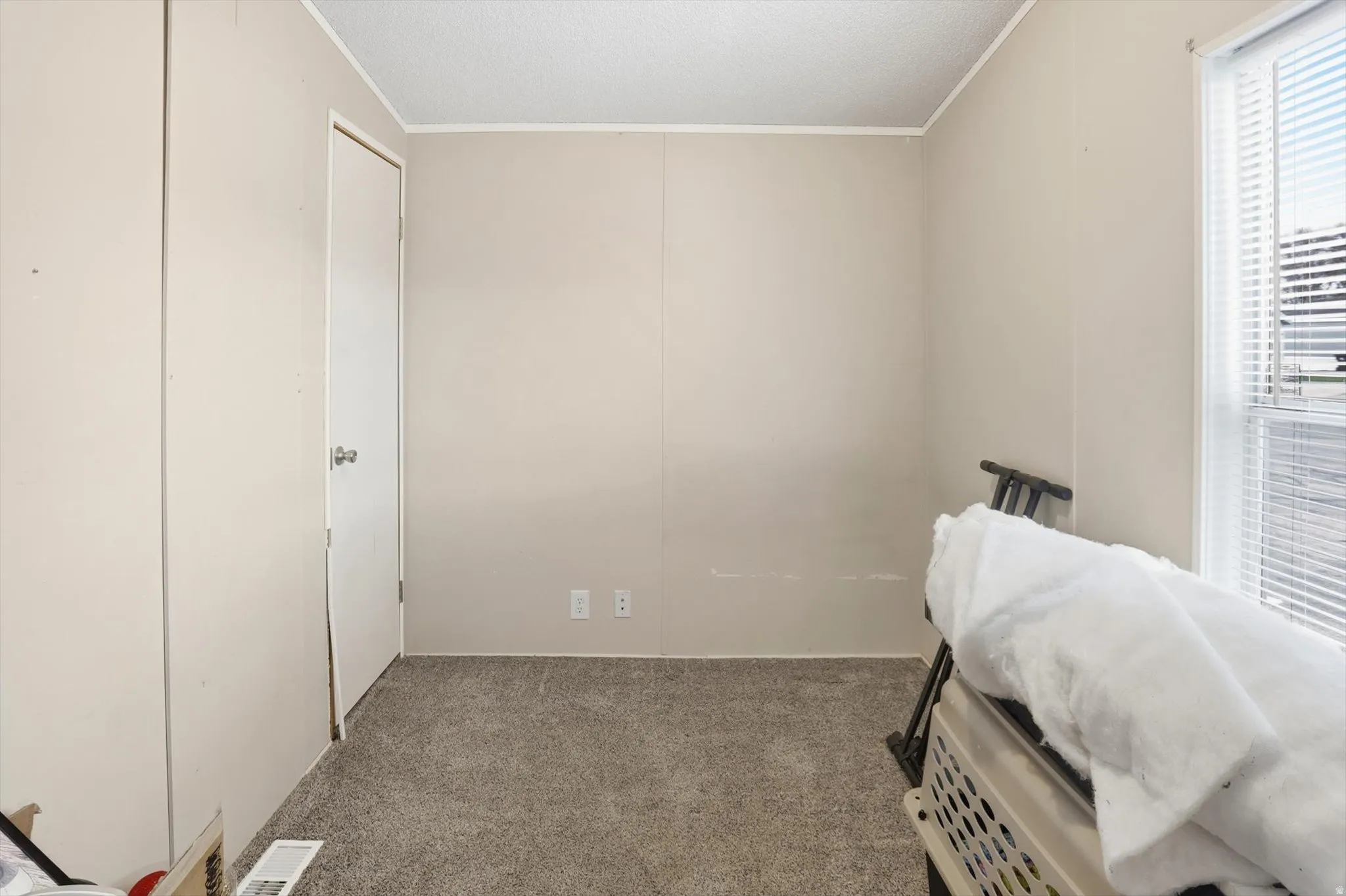 Bedroom featuring light carpet and ornamental molding