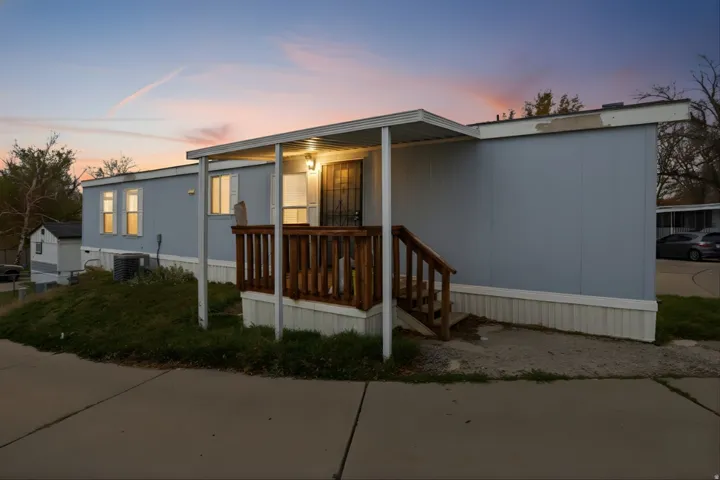 Manufactured / mobile home featuring a porch and a front yard