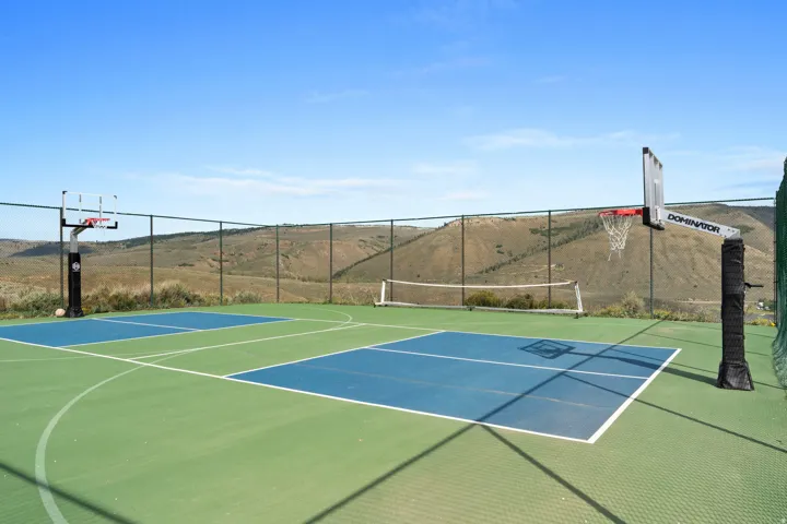 View of tennis court featuring community basketball court