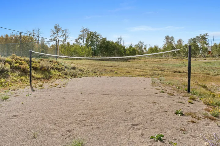 View of home's community with volleyball court and a view of rural / pastoral area