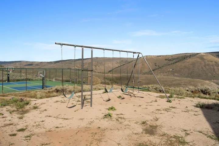 View of yard with a mountain view and community basketball court