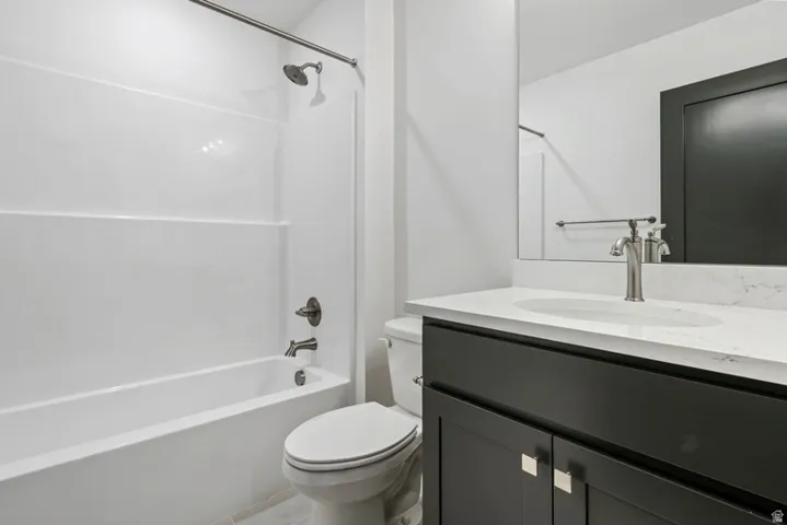 Bathroom featuring vanity and bathtub / shower combination