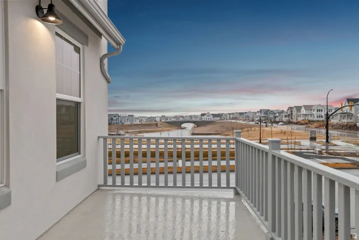 Balcony at dusk featuring a residential view