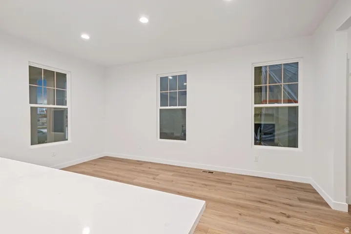 Unfurnished room with light wood finished floors and recessed lighting