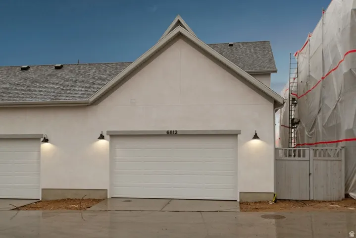 Garage featuring concrete driveway