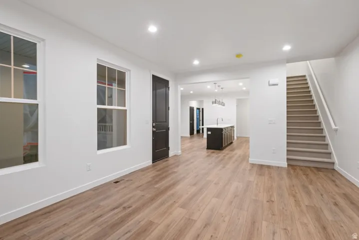 Unfurnished living room featuring recessed lighting and light wood-style floors