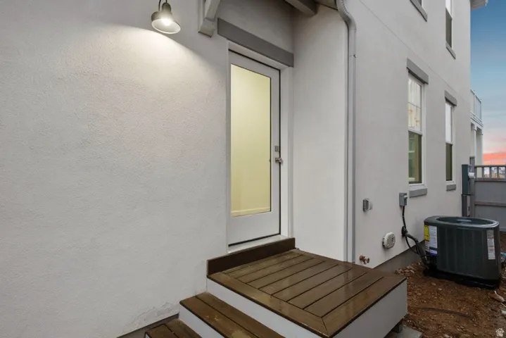 Doorway to property with stucco siding