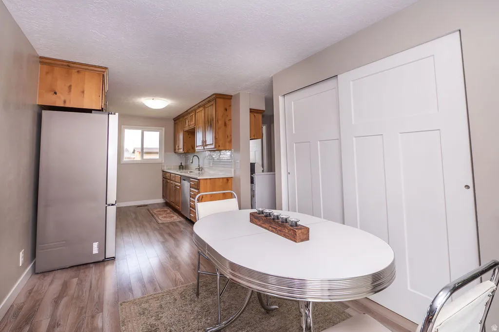 Dining space featuring dark wood-type flooring and a textured ceiling