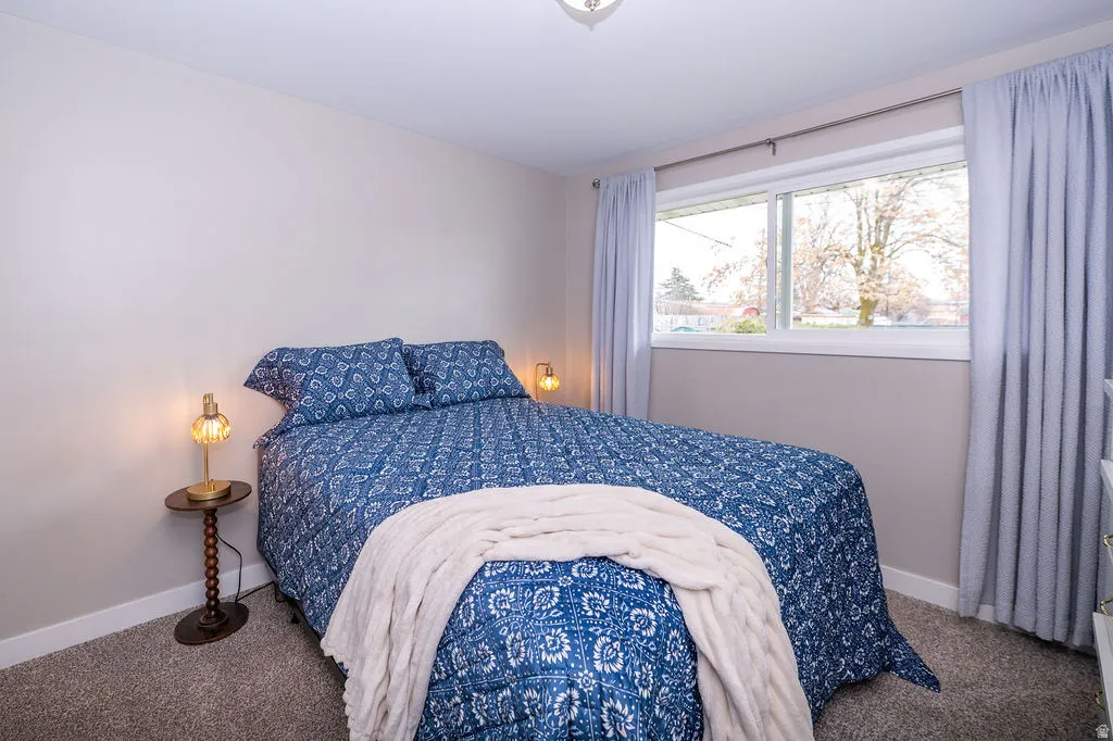 Bedroom featuring carpet flooring and baseboards