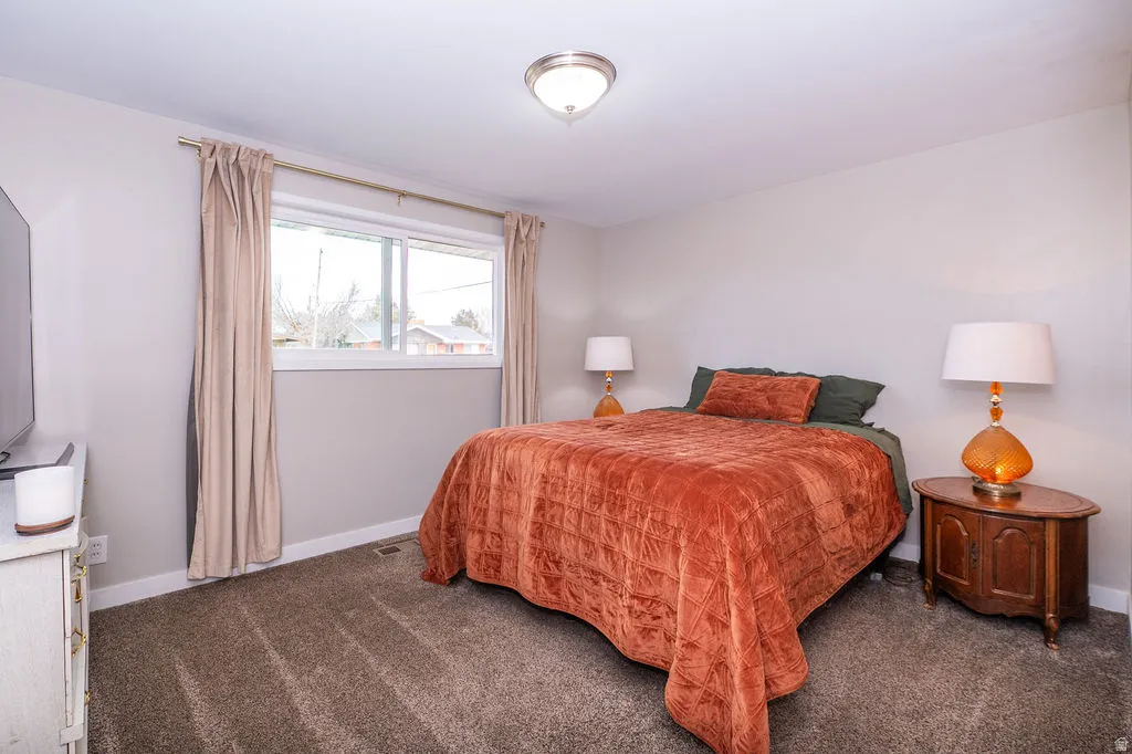 Bedroom with dark colored carpet