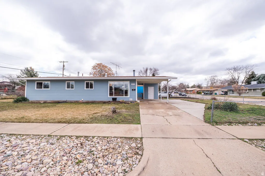 Single story home with a carport and driveway
