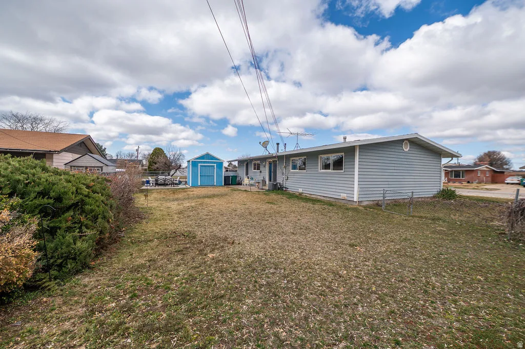Rear view of house featuring a shed