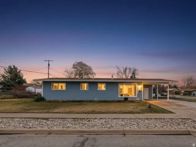 View of front of property featuring concrete driveway and a porch