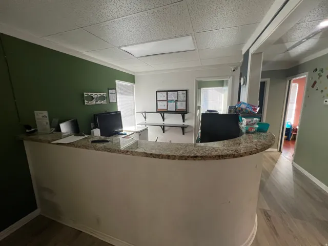 Office area featuring light wood-style flooring, a paneled ceiling, and plenty of natural light