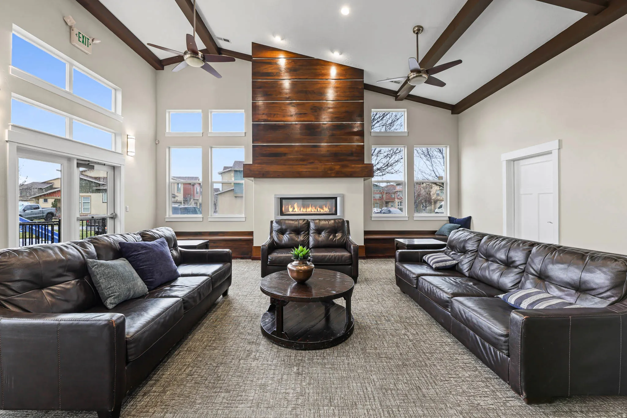 Living area featuring a fireplace, ceiling fan, vaulted ceiling, and recessed lighting