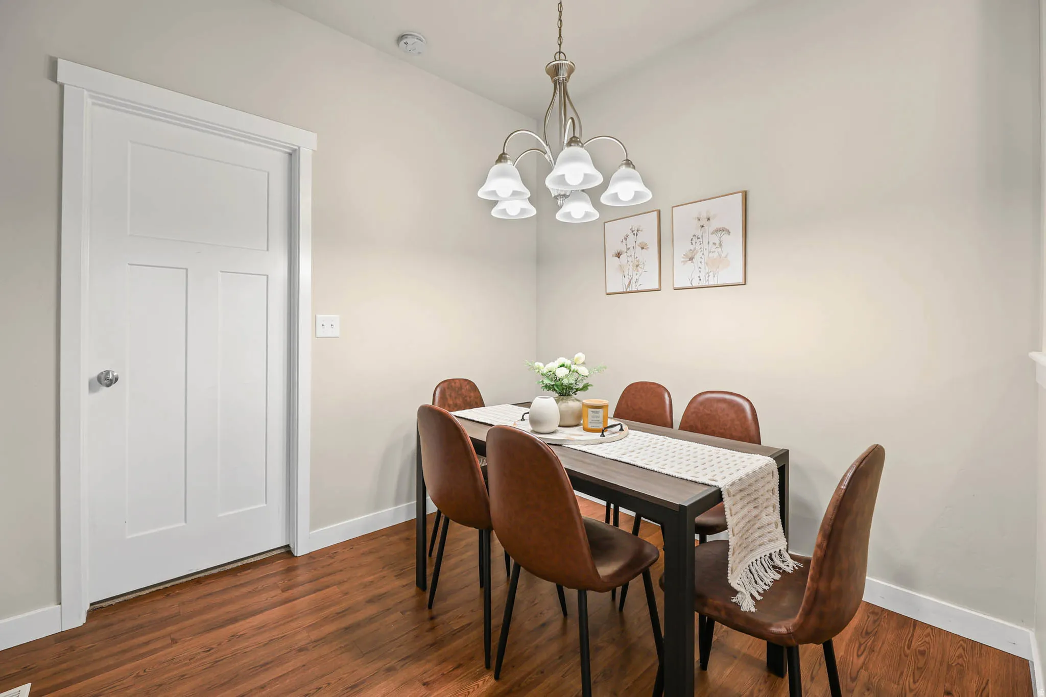 Dining area with hanging lights and wood finished floors
