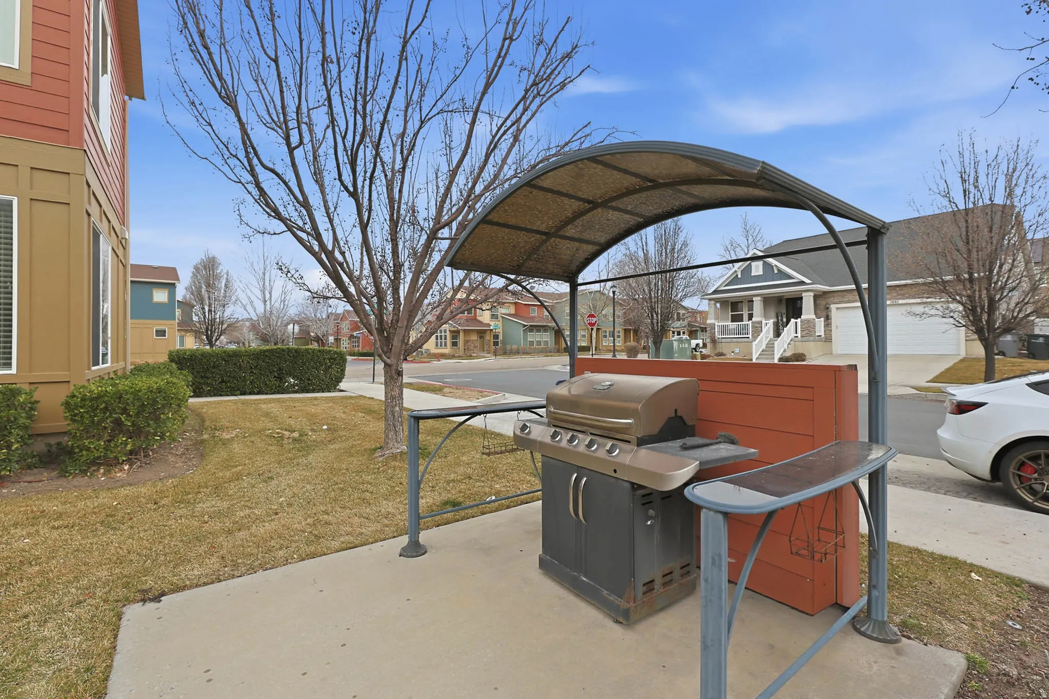 View of patio with a residential view and grilling area