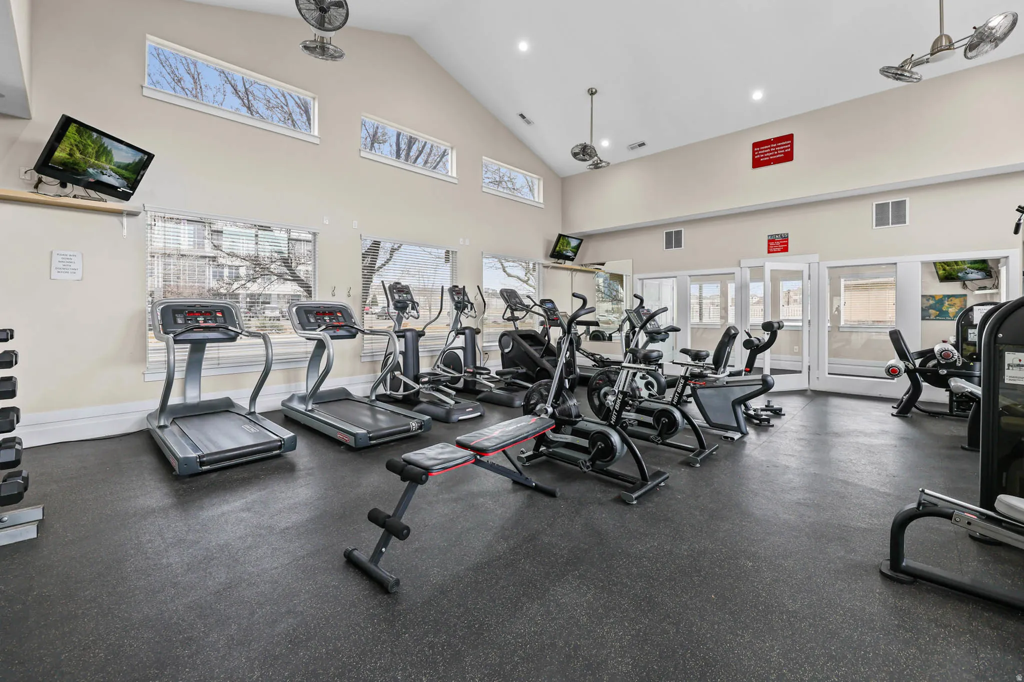 Gym featuring vaulted ceiling and recessed lighting