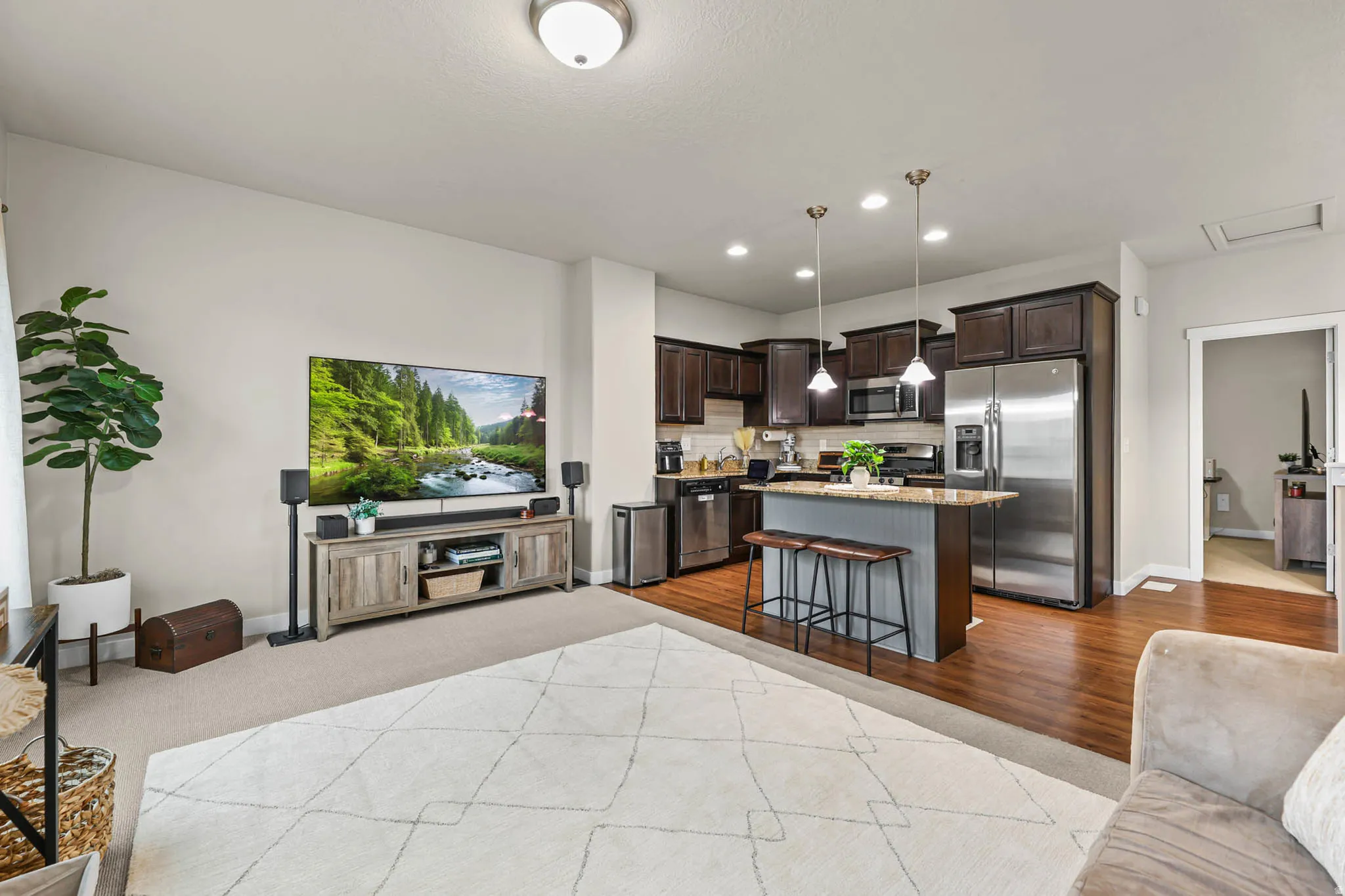 Living area with recessed lighting and light wood-style floors