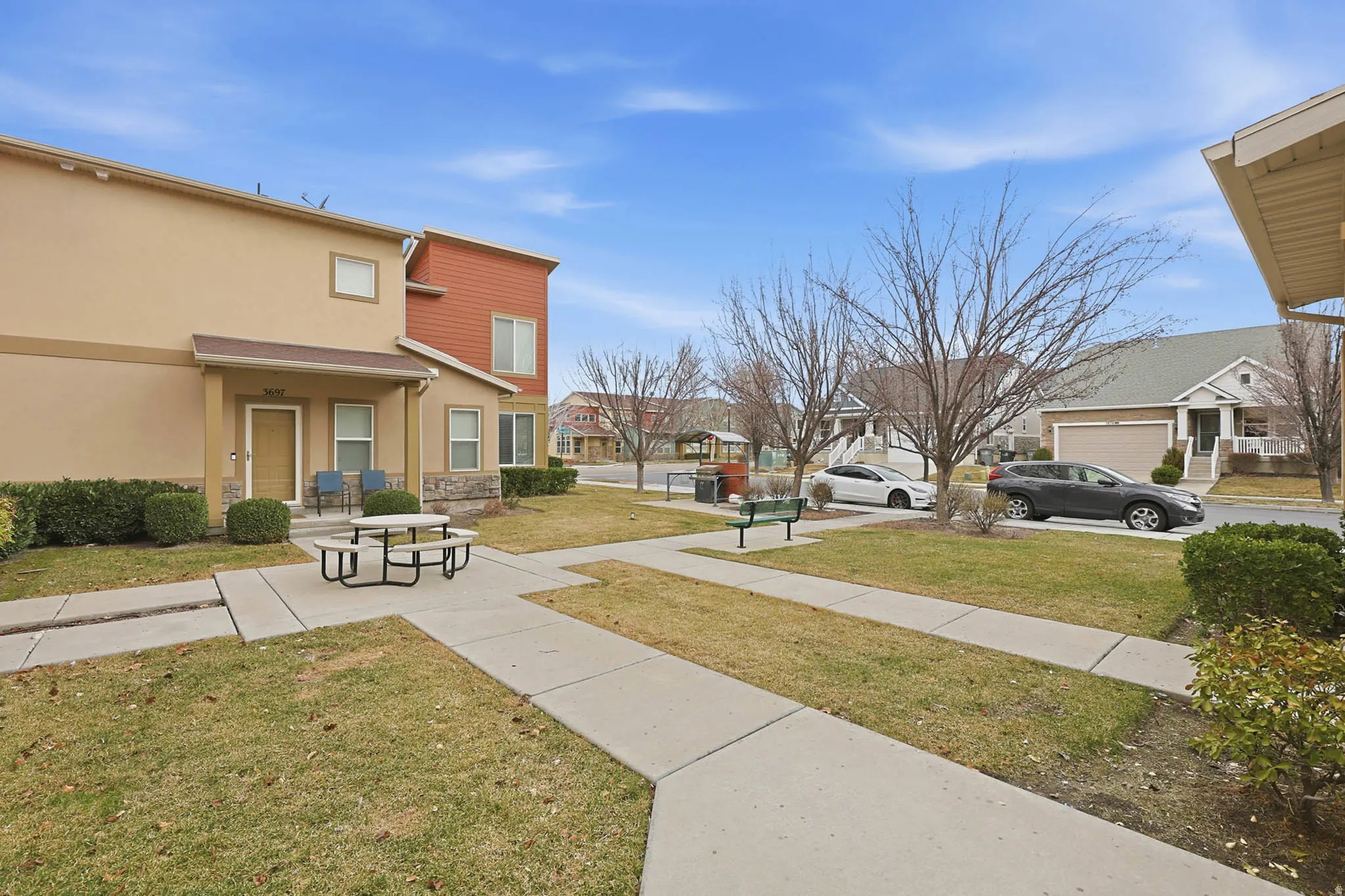 View of green lawn with a residential view and a porch
