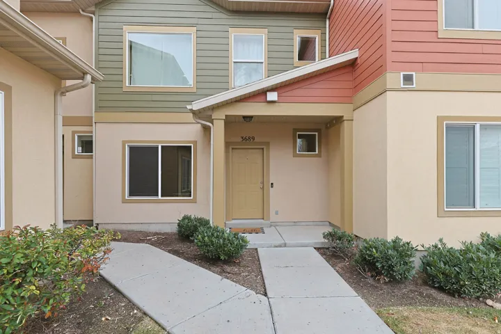 Entrance to property featuring covered porch and stucco siding