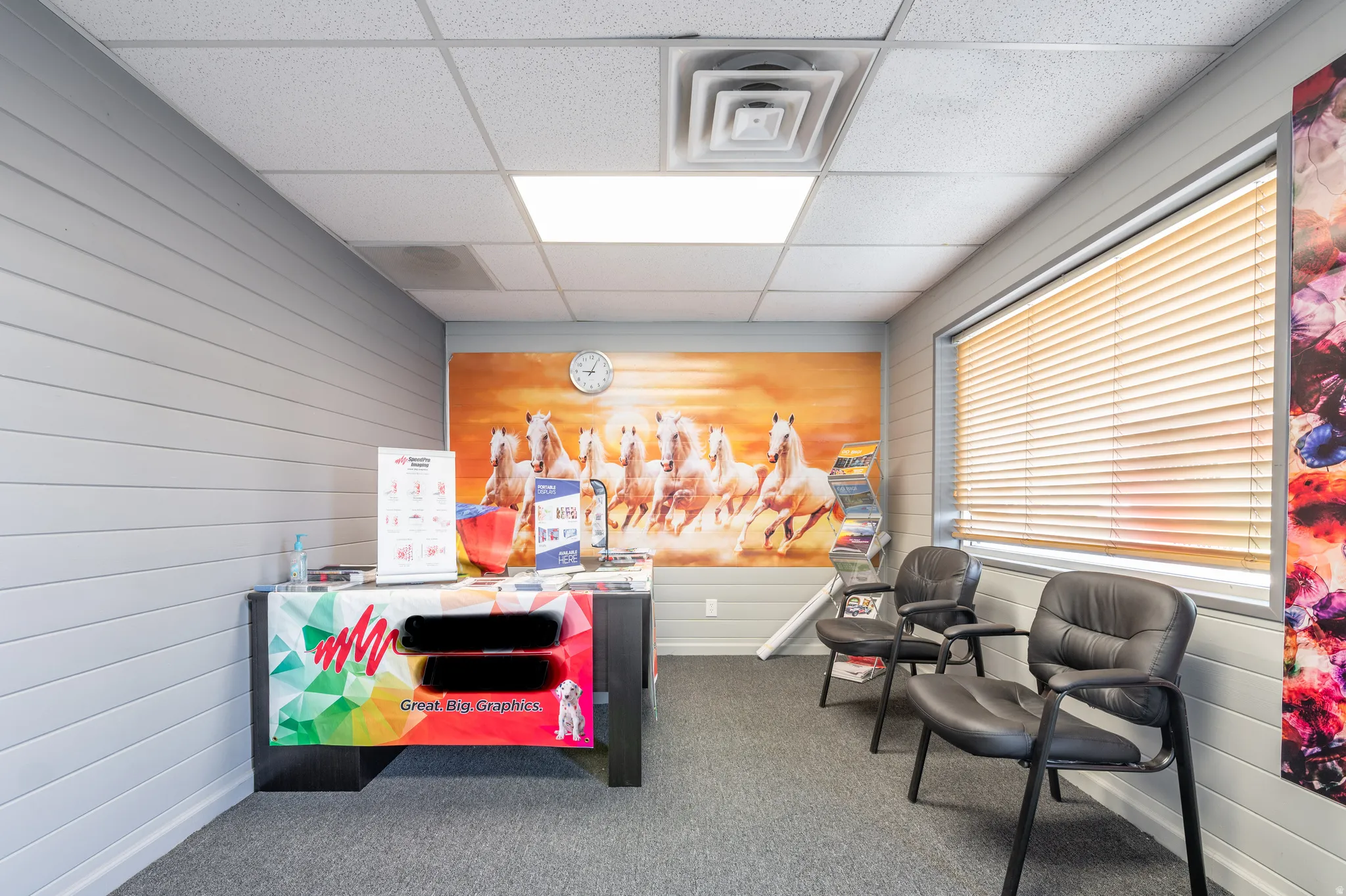 Miscellaneous room featuring a paneled ceiling and wood walls