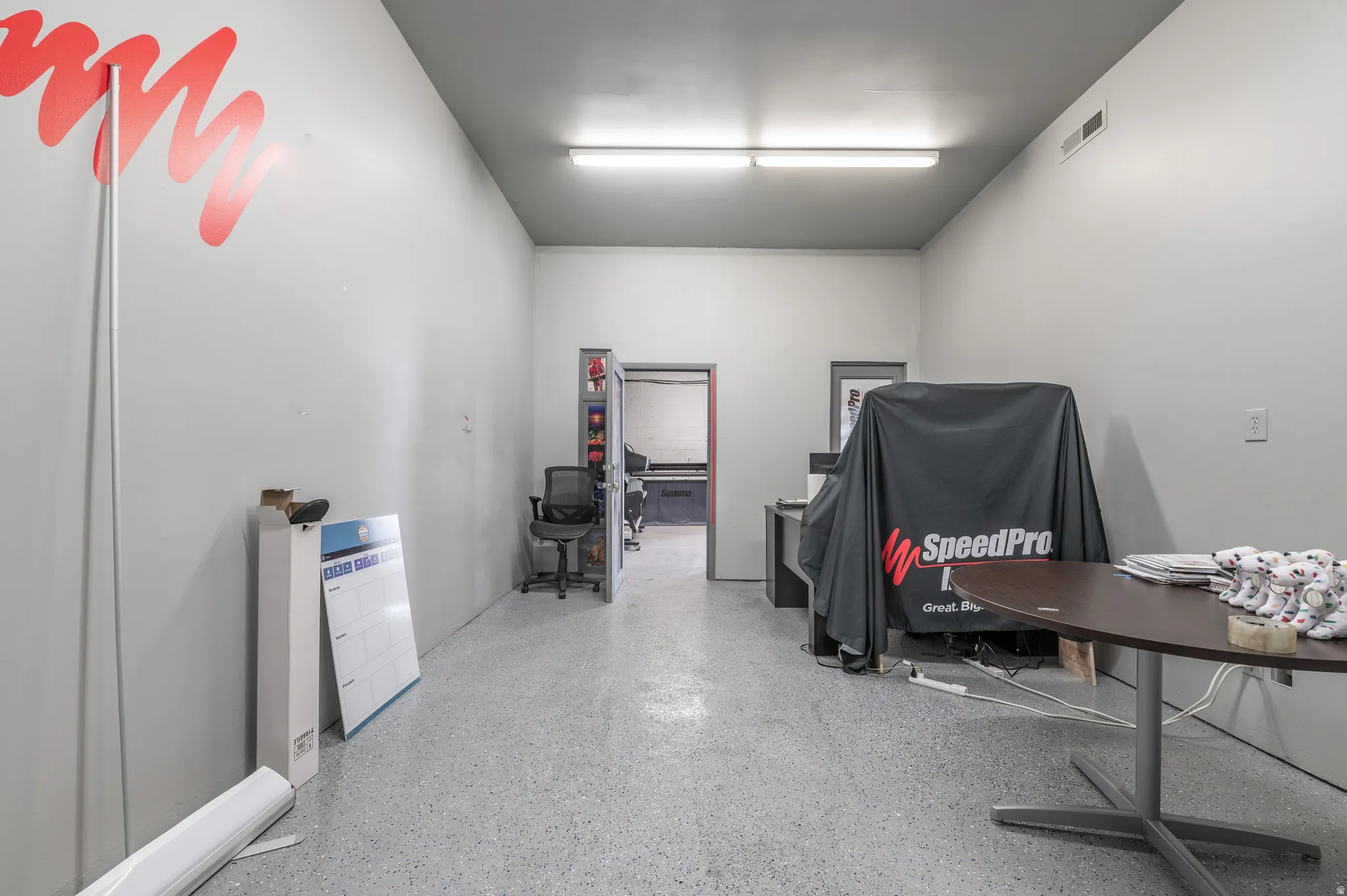 Miscellaneous room featuring dark speckled floor