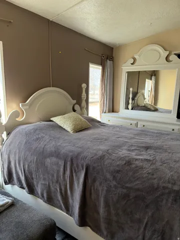 Bedroom with a textured ceiling
