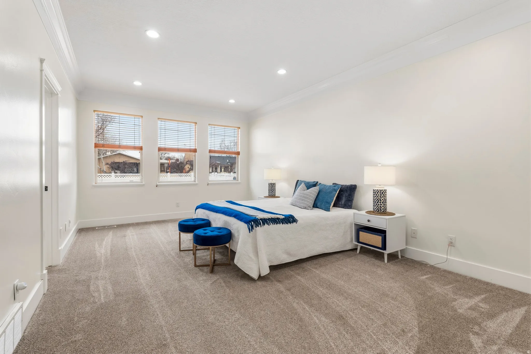 Bedroom with crown molding, light carpet, and recessed lighting