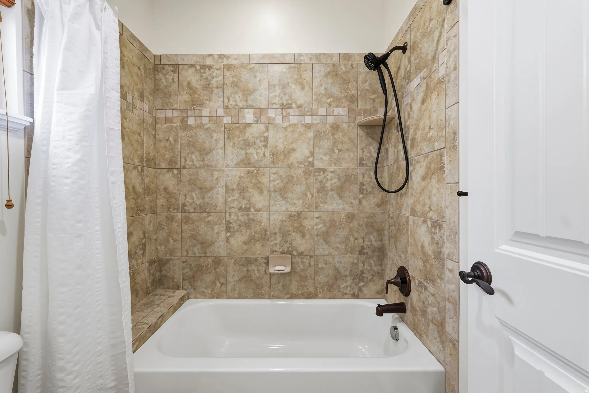 Full bathroom featuring shower / bath combo with shower curtain