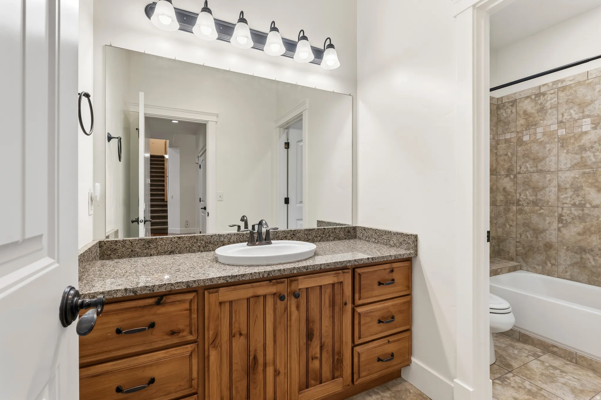 Bathroom with vanity and bathing tub / shower combination