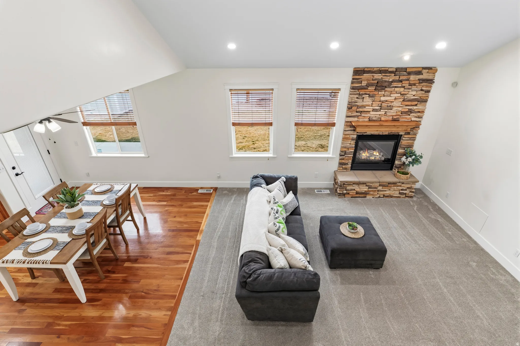 Living room with a fireplace, recessed lighting, wood finished floors, and ceiling fan