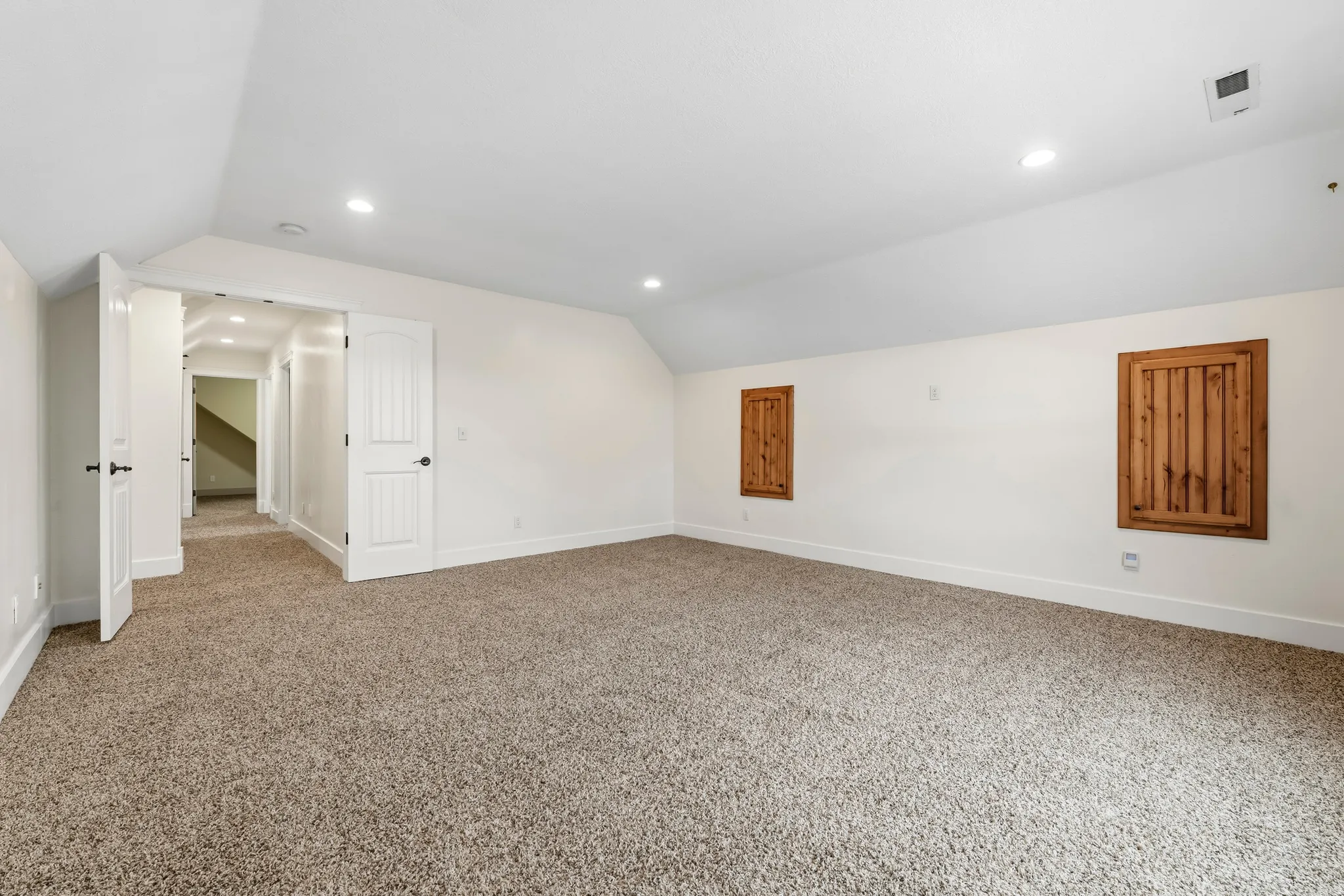 Additional living space with lofted ceiling, carpet, and recessed lighting