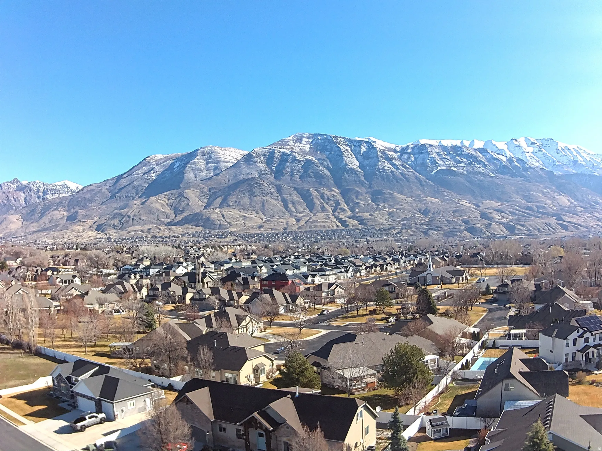View of mountain background featuring nearby suburban area