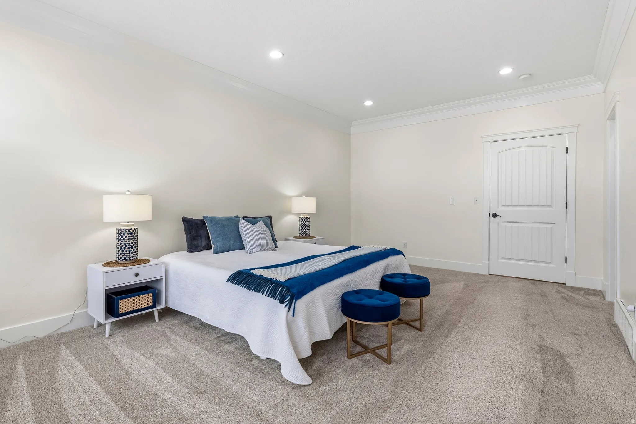 Bedroom with ornamental molding, light carpet, and recessed lighting