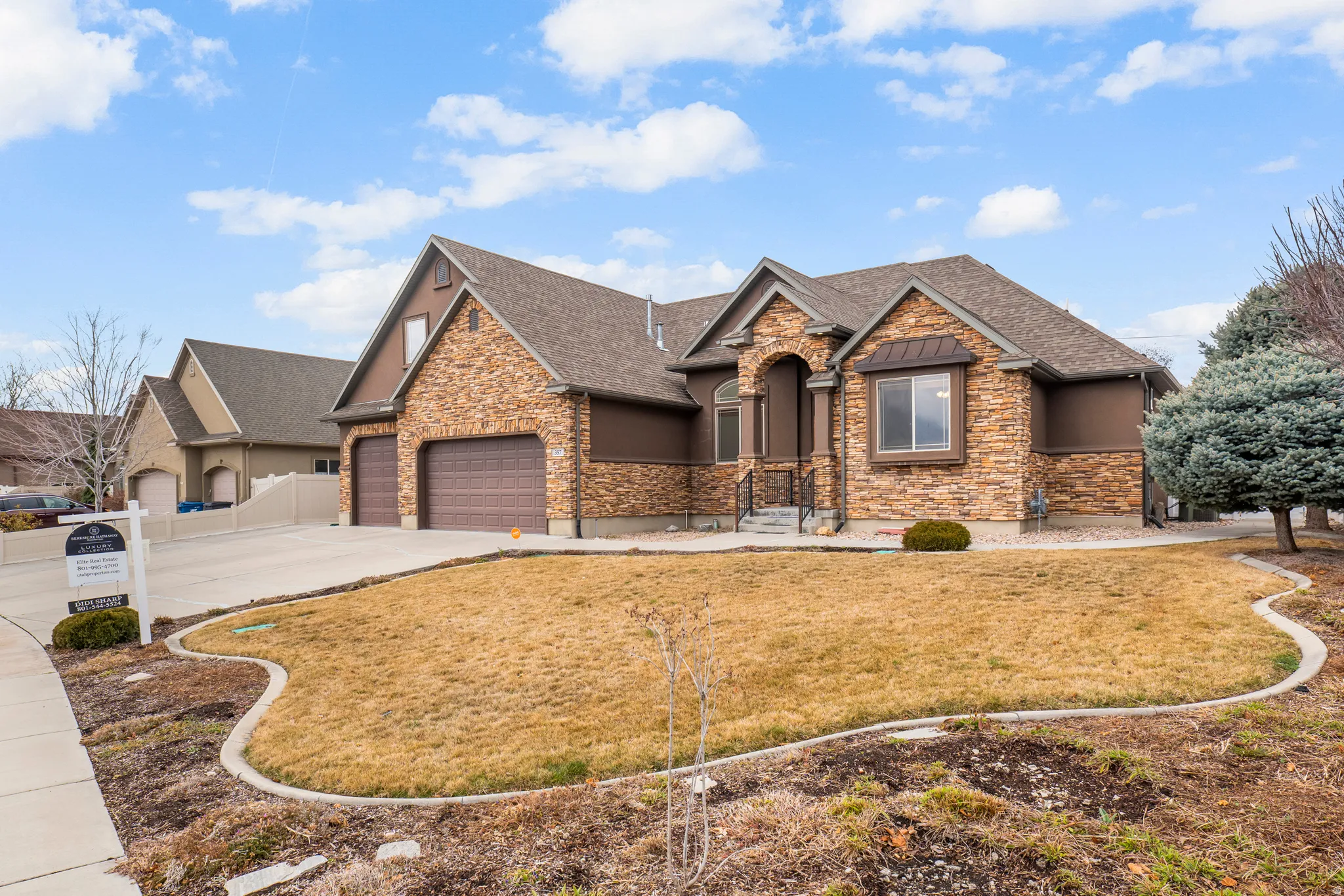 Craftsman house with a front yard, stone siding, stucco siding, and roof with shingles
