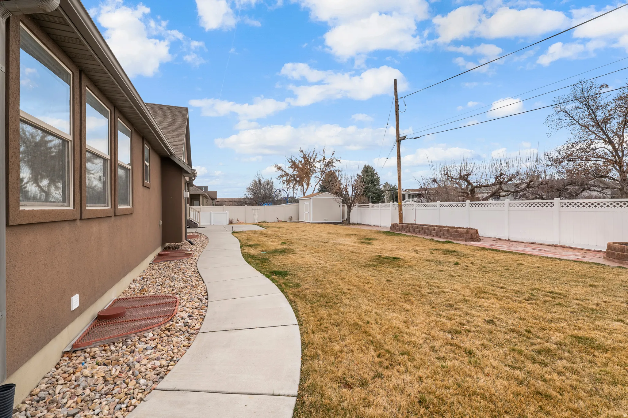 Fenced backyard with a storage unit