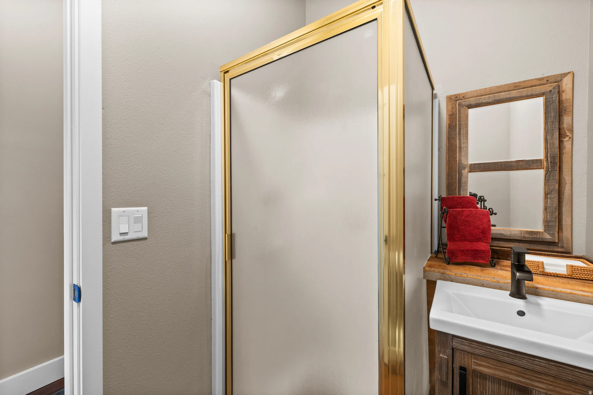 Full bath with vanity and a shower stall