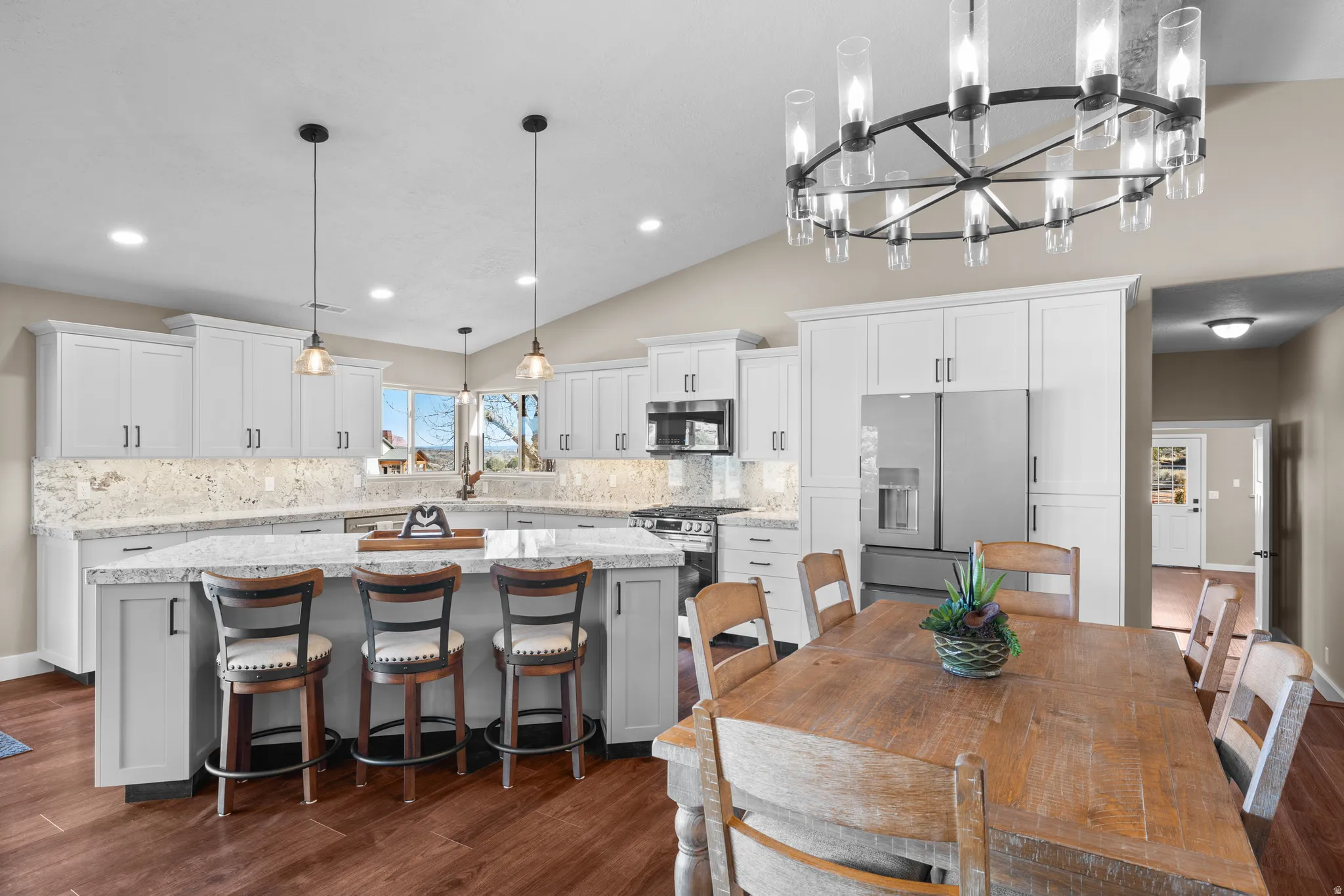 Kitchen/Dining room featuring vaulted ceiling, and island seating