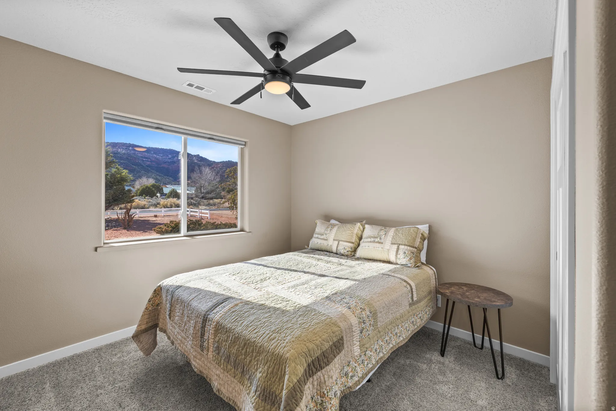 Bedroom featuring a red rock views, ceiling fan, and carpet floors