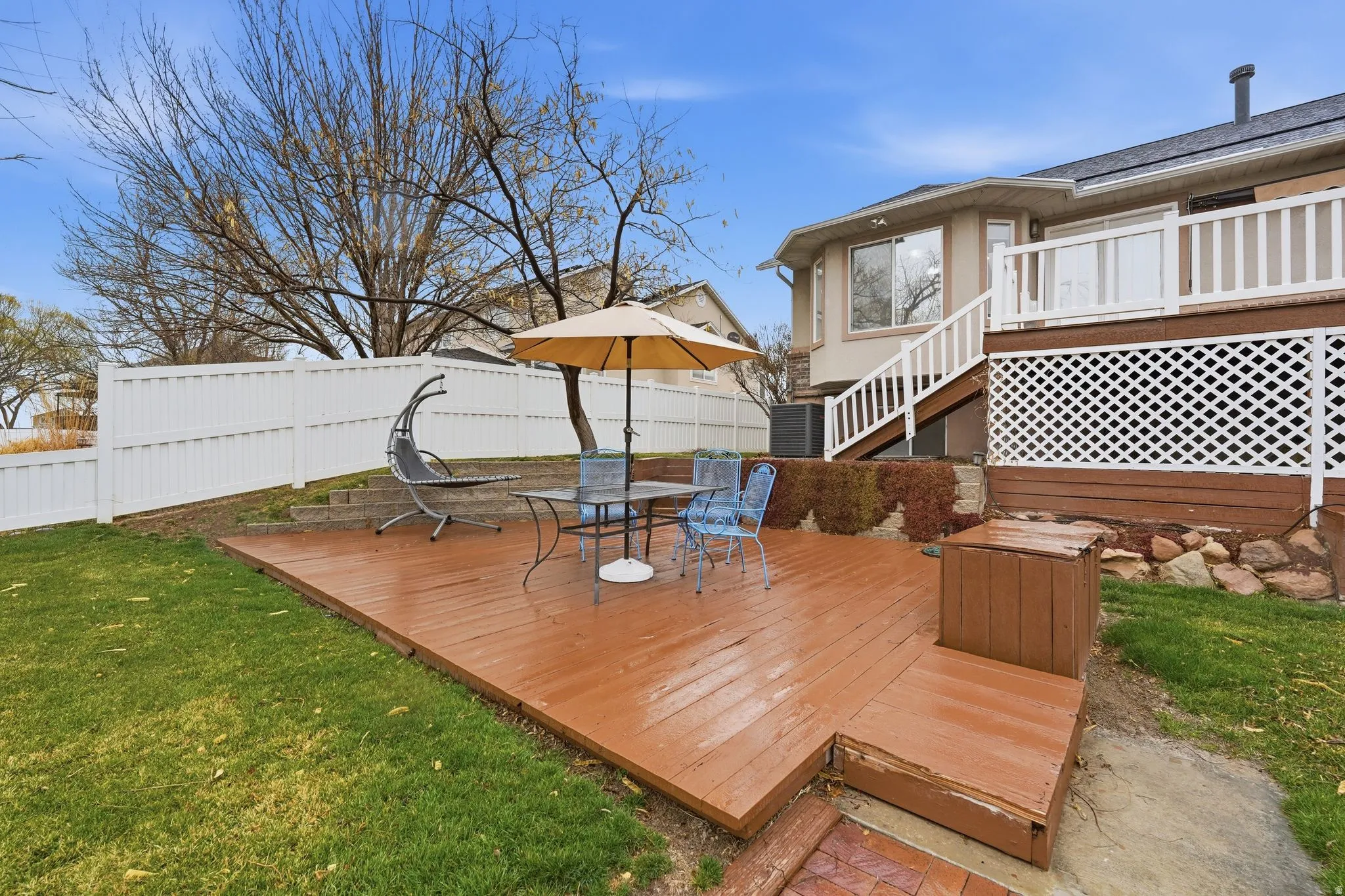 Deck with outdoor dining space and a fenced backyard